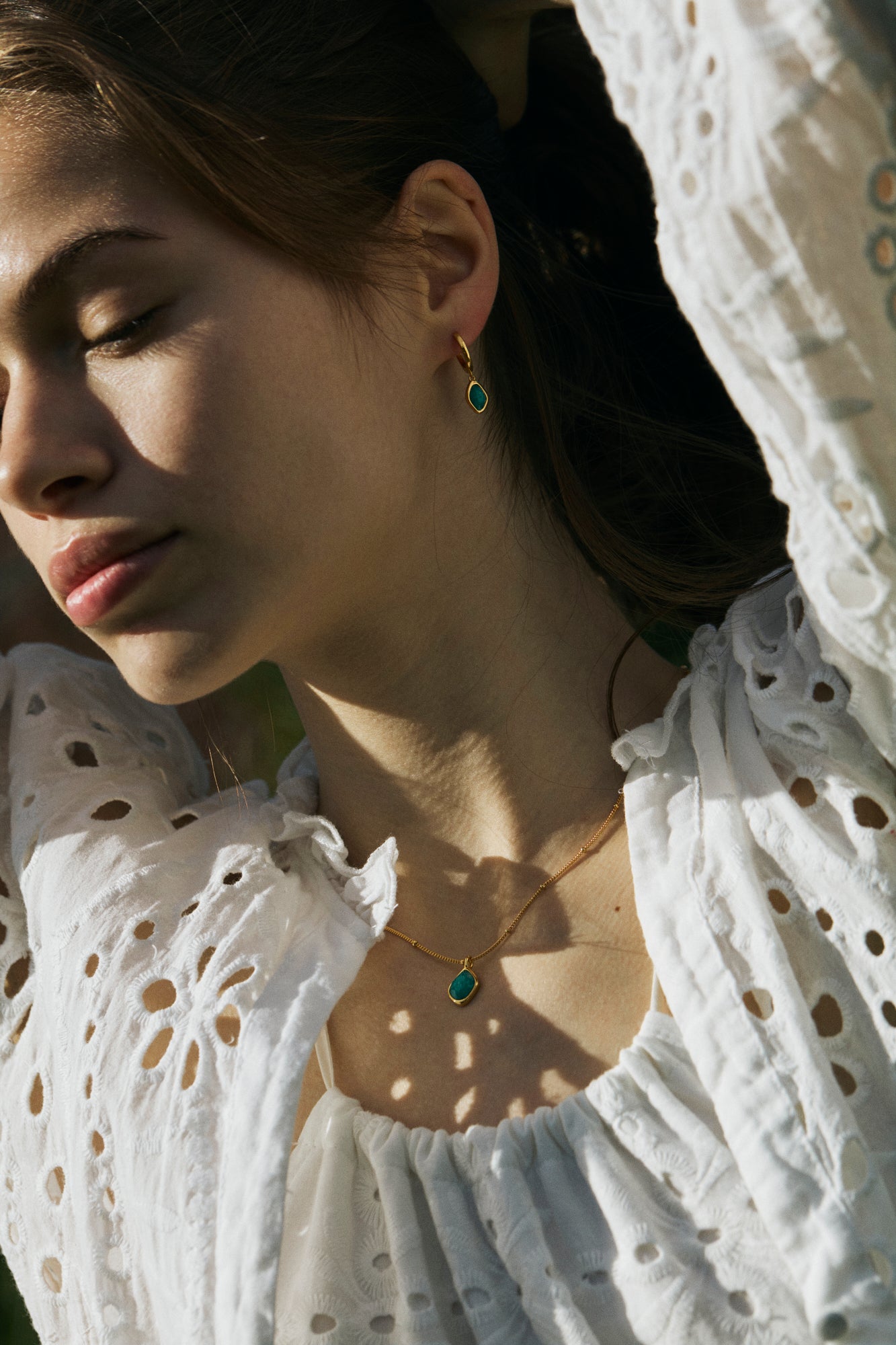 Woman wearing gold amazonite dangle earrings and necklace 