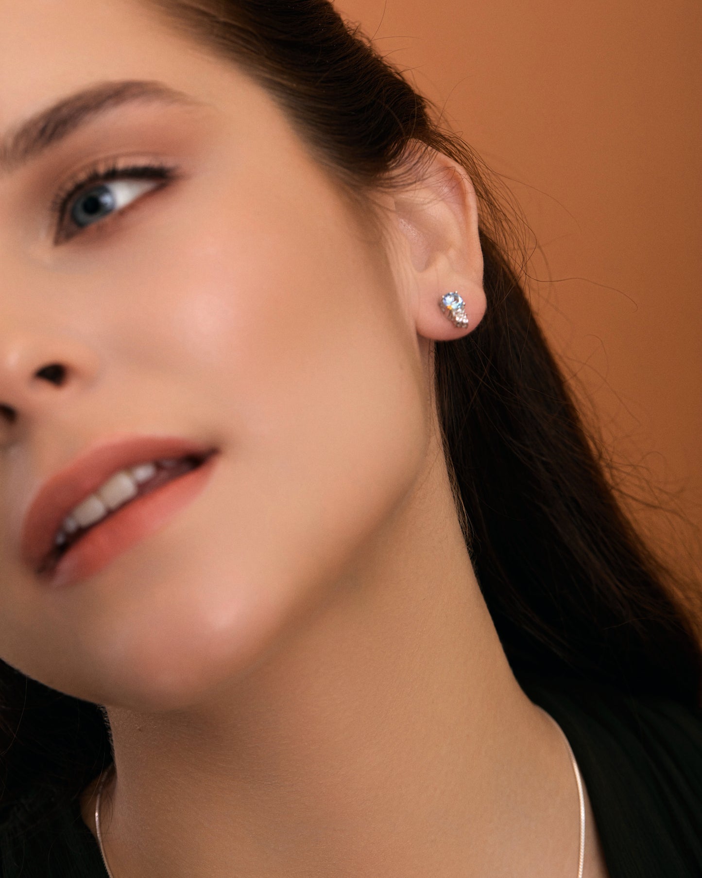 Sky blue topaz & white topaz star earrings on  model