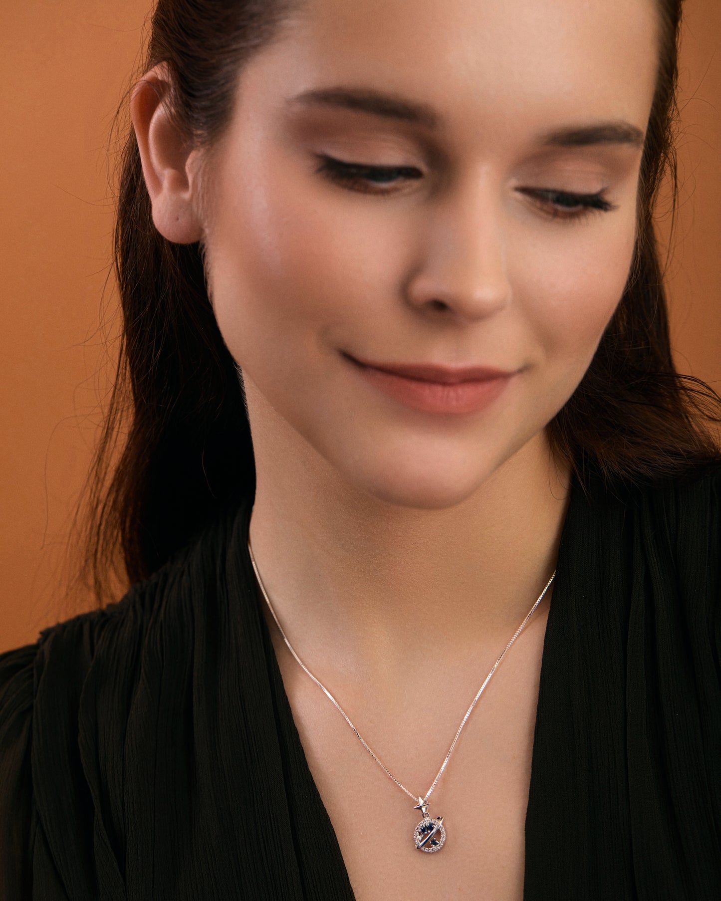 Saturn inspired blue sapphire necklace on model