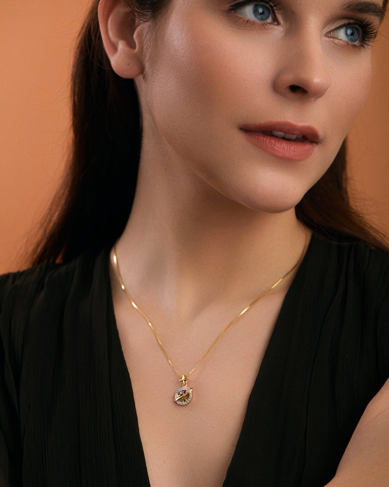 Saturn inspired gold necklace on model