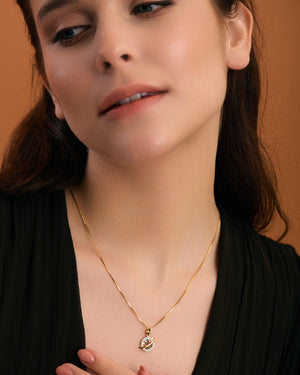 Saturn inspired gold necklace on model