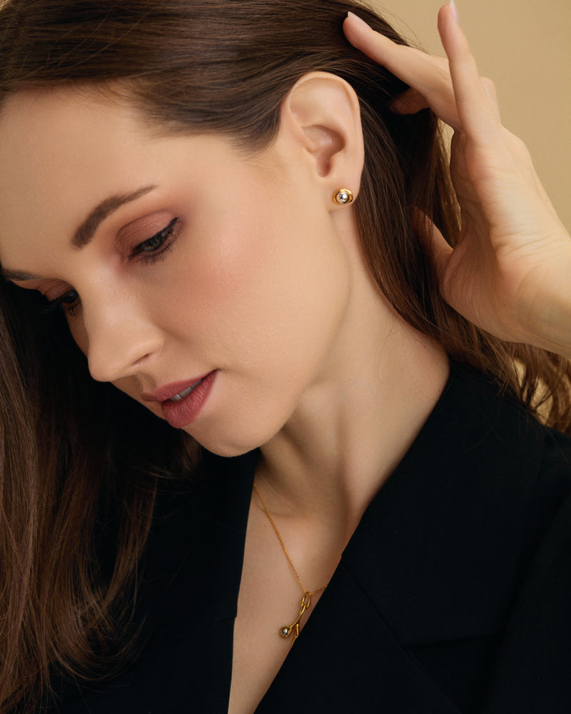 Seed inspired Two Tone Gold Silver Stud Earrings on model