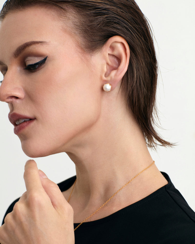 
                
                    Load image into Gallery viewer, Contemporary styled White fresh water pearl 18K gold vermeil stud earrings on model
                
            