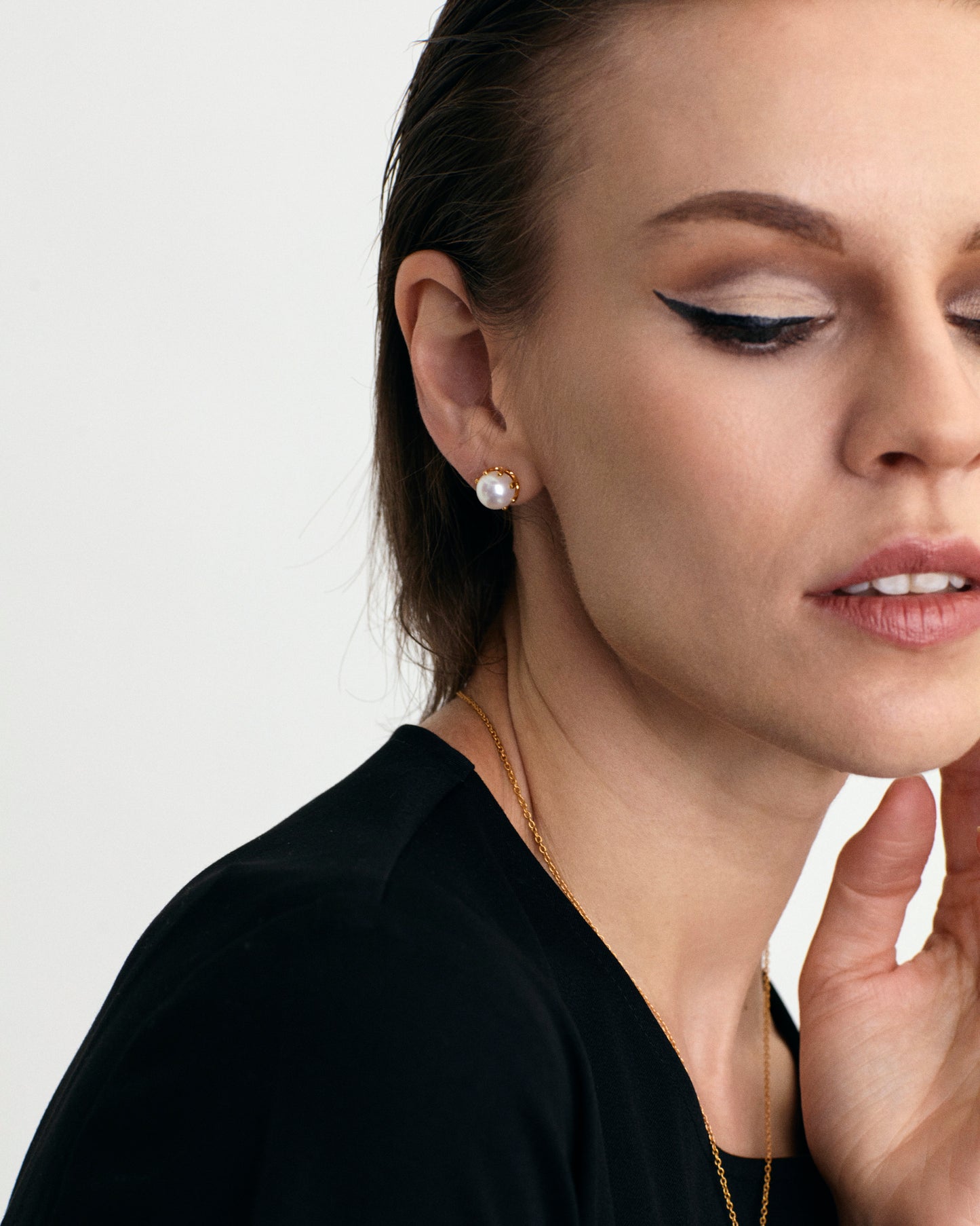 Contemporary styled White fresh water pearl 18K gold vermeil stud earrings on model